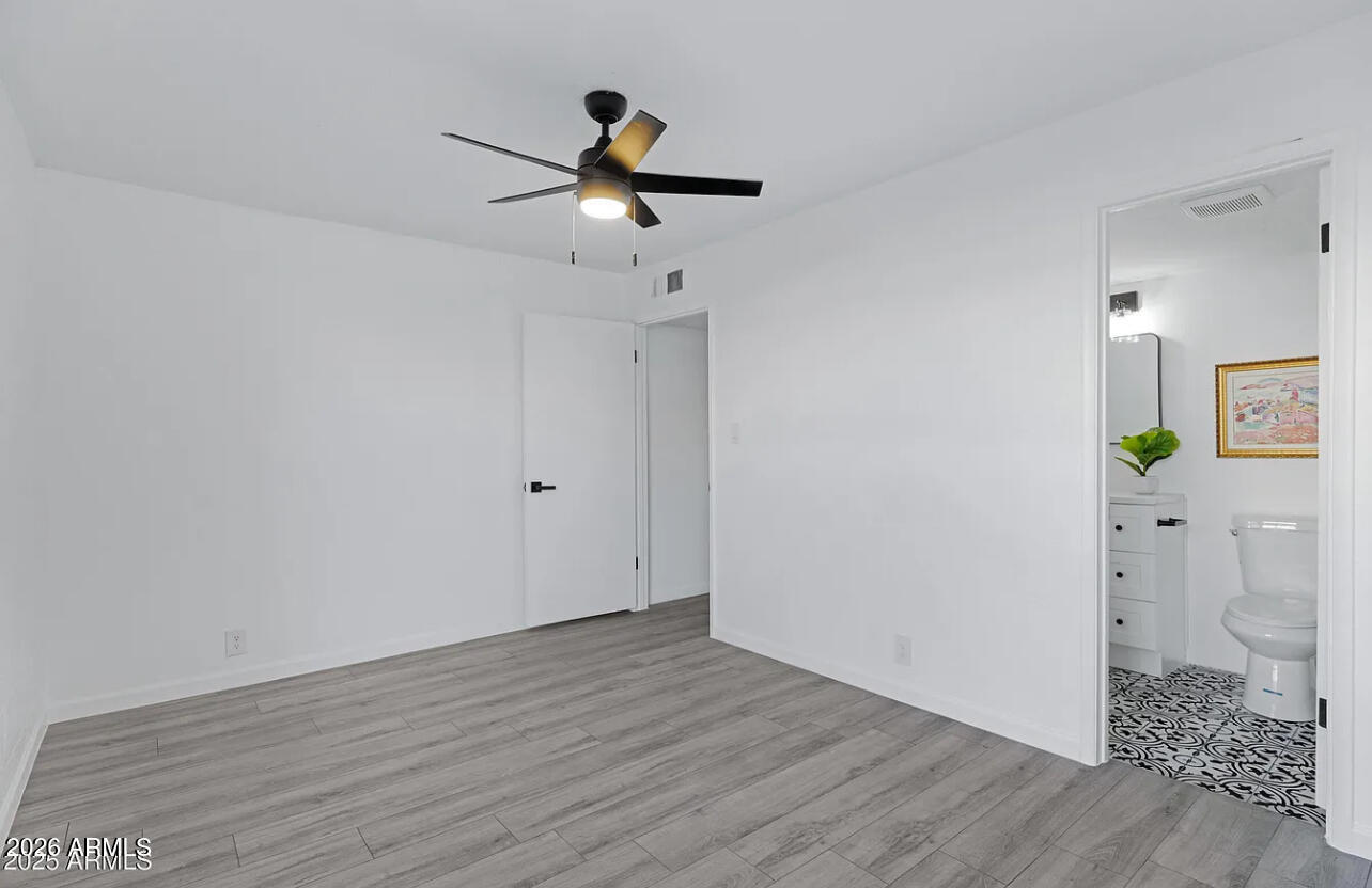 1101 East Bethany Home Road, Unit 15 Phoenix, AZ 85014 - Photo 16 of 16 a view of empty room with wooden floor