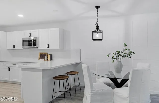 a dining room with furniture and a chandelier
