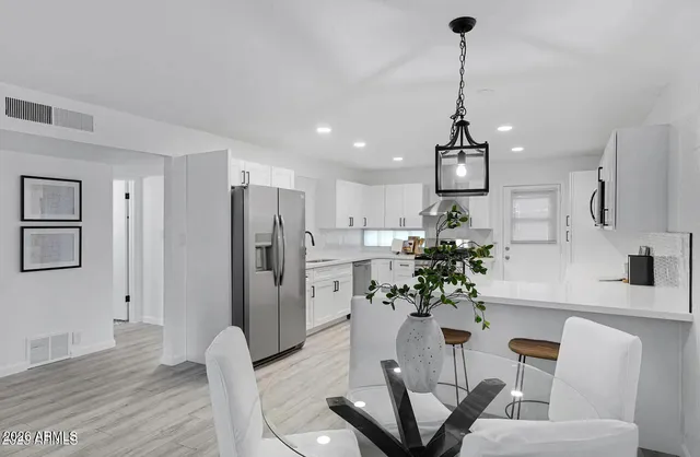 a kitchen with stainless steel appliances a sink stove and refrigerator