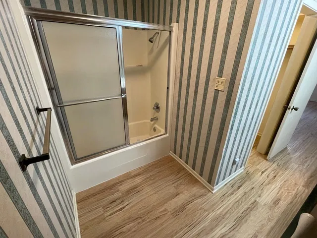 a view of a room with wooden floor and staircase