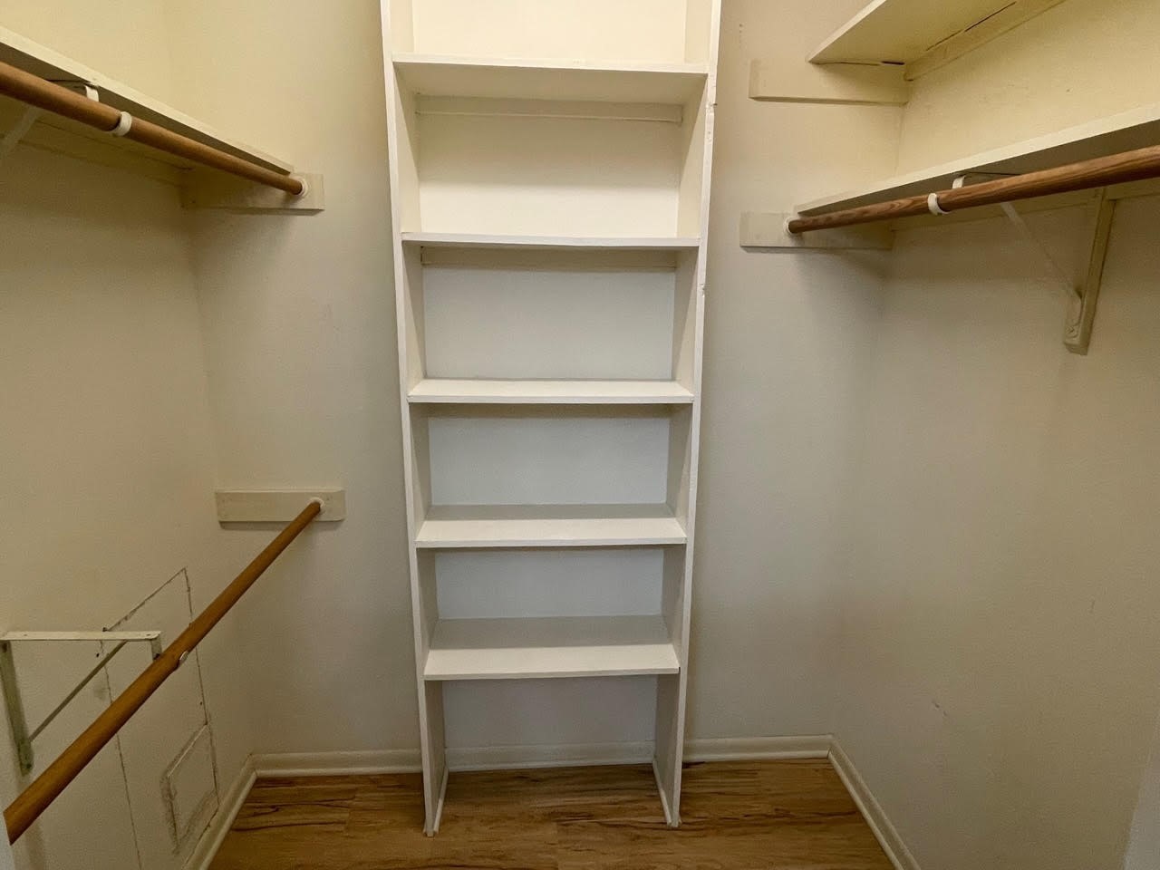1732 Ave C, Unit A El Campo, TX 77437 - Photo 12 of 22 a view of walk in closet with empty racks