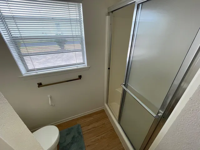 a bathroom with a window and toilet