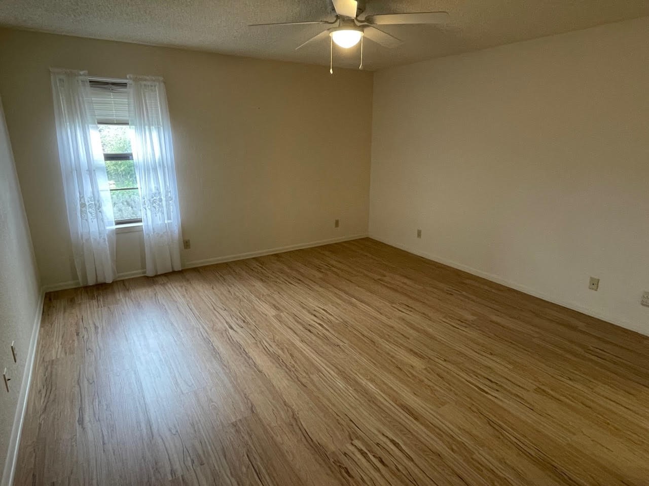 1732 Ave C, Unit A El Campo, TX 77437 - Photo 17 of 22 an empty room with wooden floor and windows