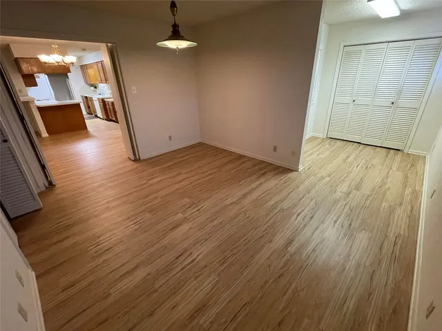 wooden floor in an empty room with a mirror