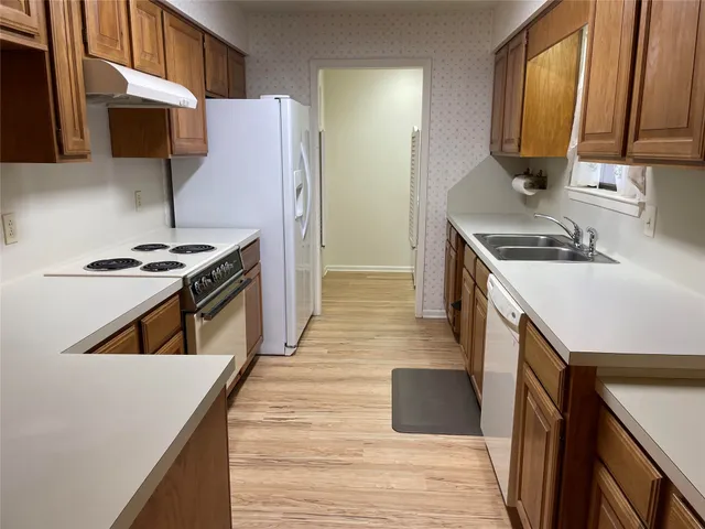 a kitchen with a stove a sink and a microwave