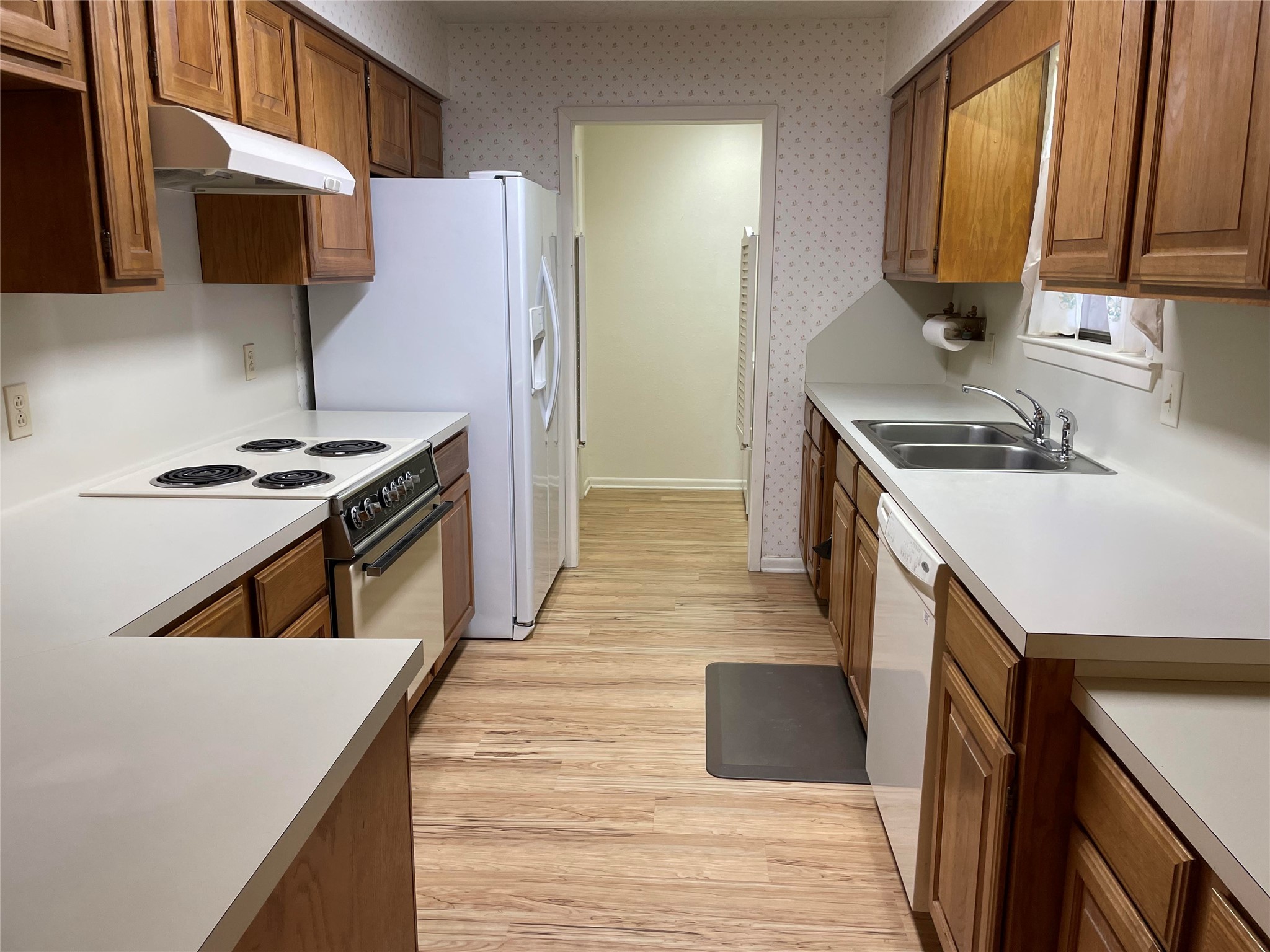 1732 Ave C, Unit A El Campo, TX 77437 - Photo 3 of 22 a kitchen with a stove a sink and a microwave