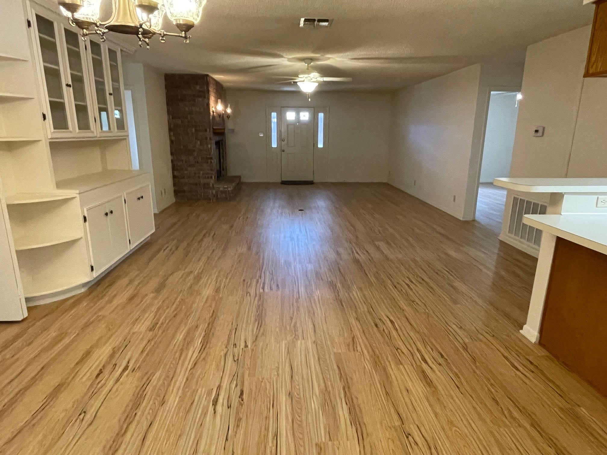 1732 Ave C, Unit A El Campo, TX 77437 - Photo 6 of 22 wooden floor in an empty room with a window