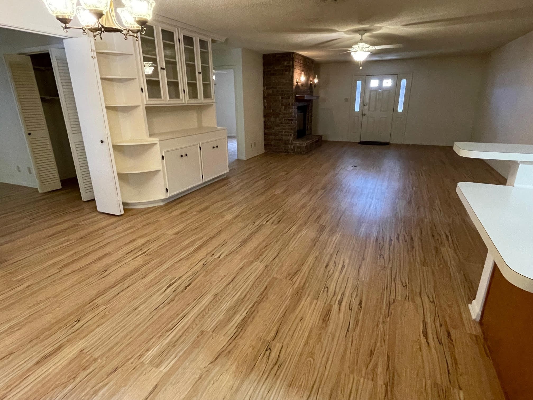 1732 Ave C, Unit A El Campo, TX 77437 - Photo 7 of 22 wooden floor in an empty room with a window