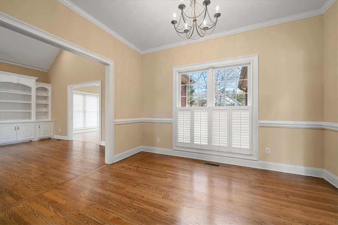 128 Cayman Way Anderson, SC 29621 - Photo 9 of 49 This bright space features rich hardwood flooring and elegant window treatments.