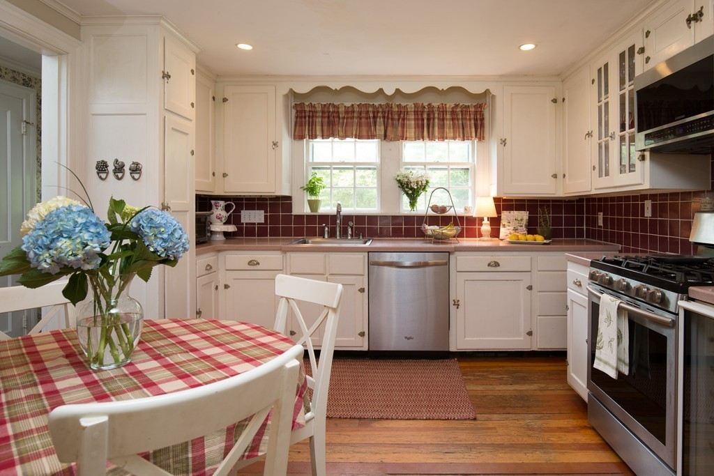 57 Fuller Brook Road Wellesley, MA 02482 - Photo 2 of 12 a kitchen with a sink stove and cabinets