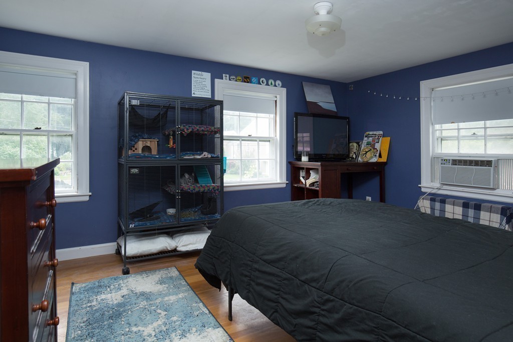 57 Fuller Brook Road Wellesley, MA 02482 - Photo 9 of 12 a bedroom with furniture and a fireplace