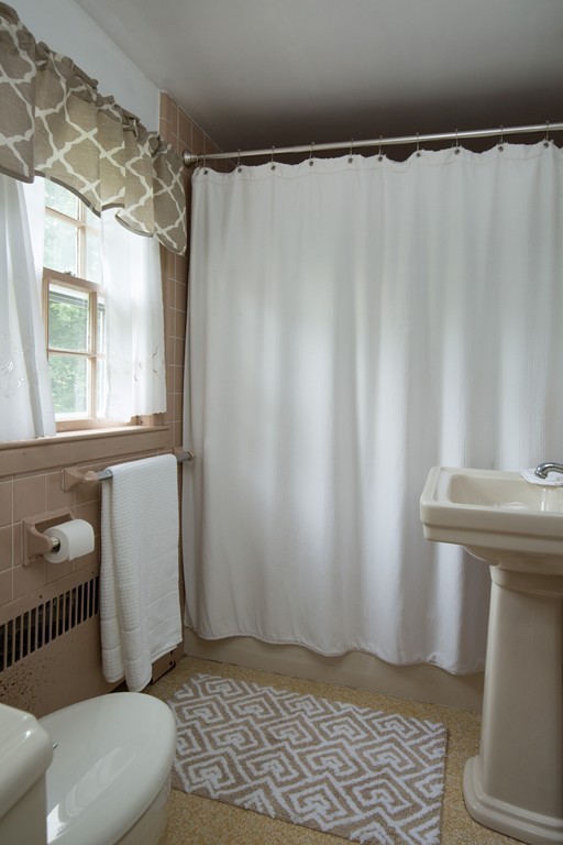 57 Fuller Brook Road Wellesley, MA 02482 - Photo 10 of 12 a bathroom with a sink toilet and shower