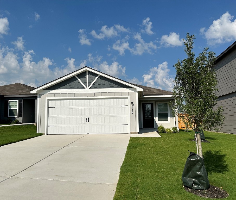 109 Morrison Drive Jarrell, TX 76537 - Photo 1 of 11 a front view of a house with a yard and garage