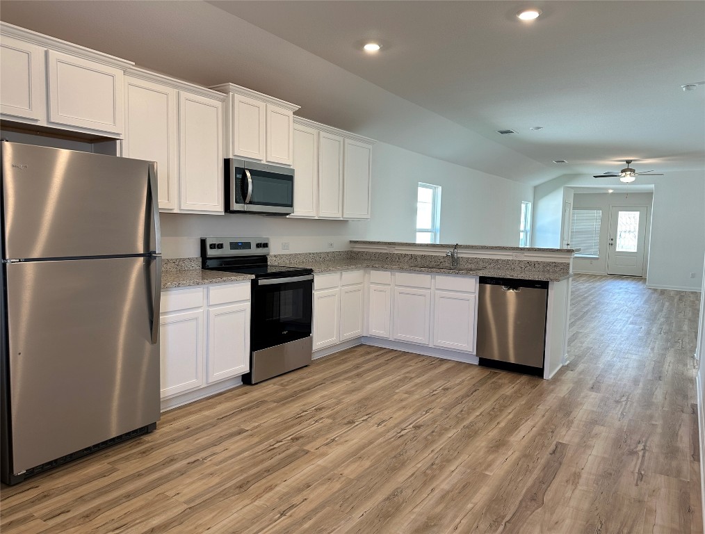 109 Morrison Drive Jarrell, TX 76537 - Photo 3 of 11 a kitchen with a refrigerator cabinets and wooden floor