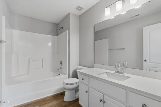 a bathroom with a sink a toilet and bathtub