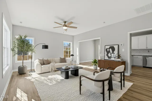 a living room with furniture and wooden floor