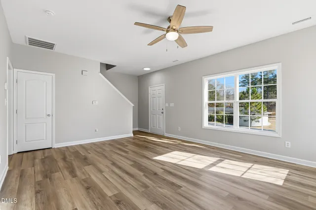 wooden floor in an empty room with a window