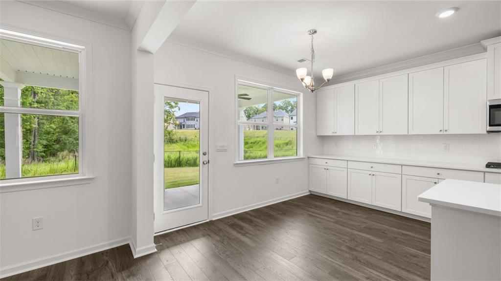 1775 Goodwin Drive Hampton, GA 30228 - Photo 14 of 49 a kitchen with wooden floors and white walls