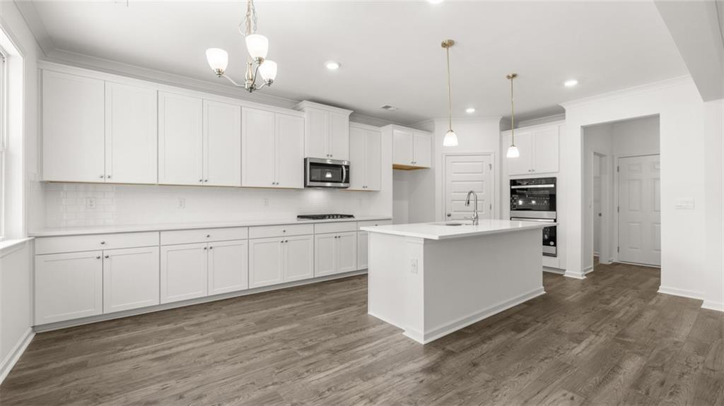 1775 Goodwin Drive Hampton, GA 30228 - Photo 15 of 49 a kitchen with white cabinets and white appliances