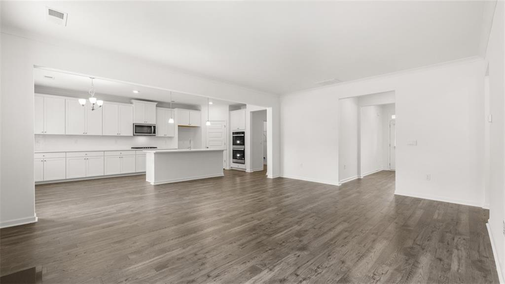 1775 Goodwin Drive Hampton, GA 30228 - Photo 16 of 49 a view of a kitchen with wooden floor and electronic appliances