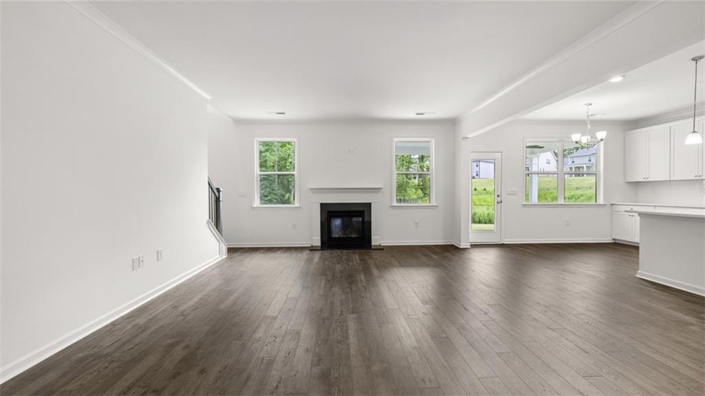 1775 Goodwin Drive Hampton, GA 30228 - Photo 17 of 49 an empty room with wooden floor and a fireplace