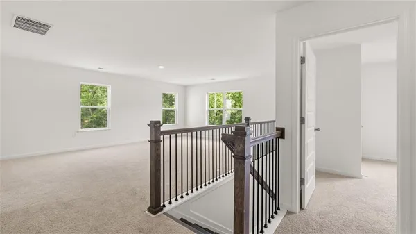 a view of a hallway with windows and stairs