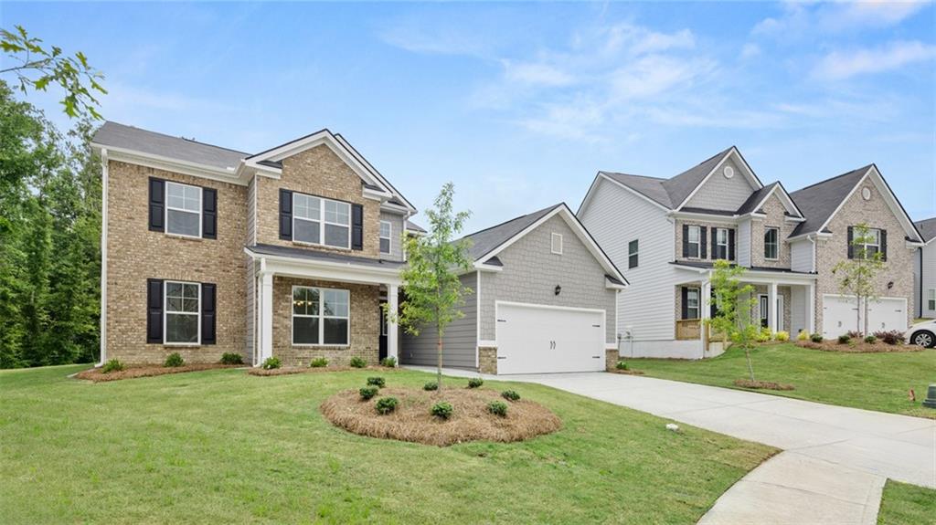 1775 Goodwin Drive Hampton, GA 30228 - Photo 2 of 49 a front view of a house with a garden