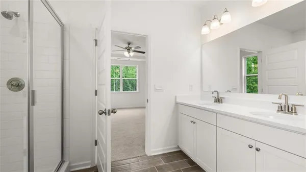 a bathroom with a double vanity sink a mirror and a shower