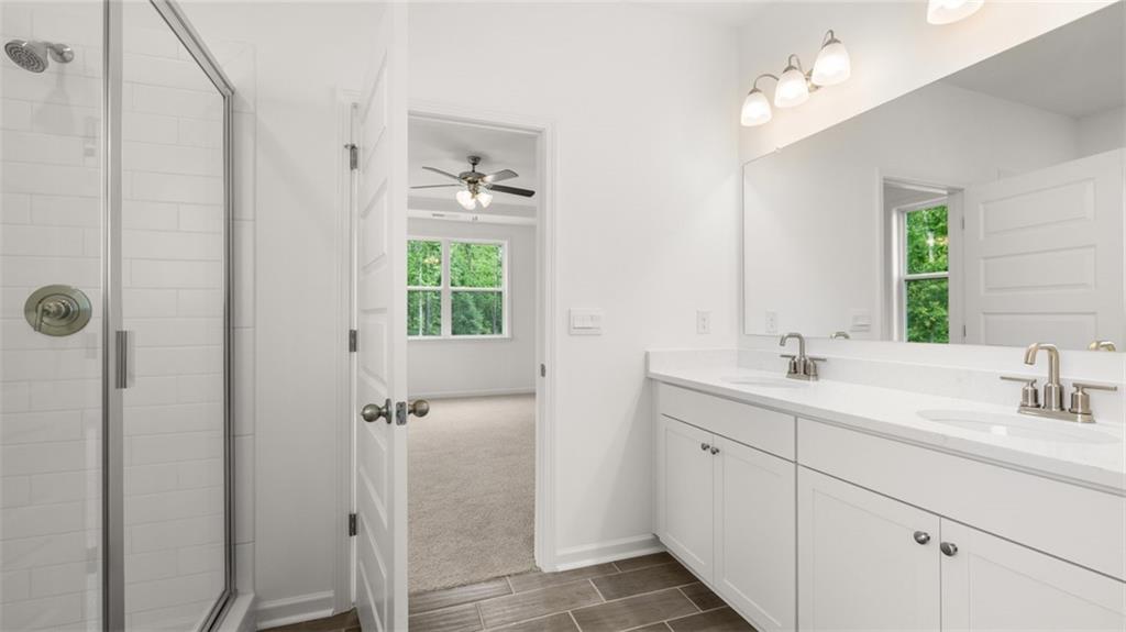 1775 Goodwin Drive Hampton, GA 30228 - Photo 28 of 49 a bathroom with a double vanity sink a mirror and a shower
