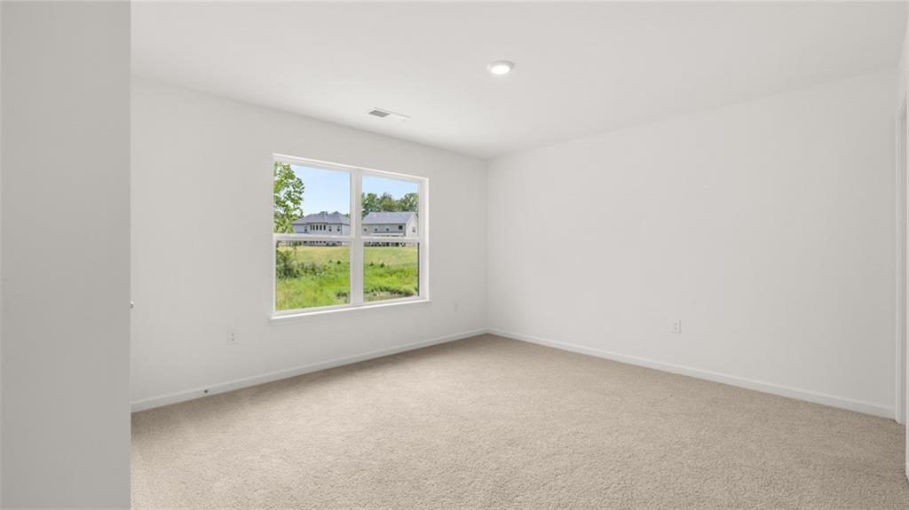 1775 Goodwin Drive Hampton, GA 30228 - Photo 32 of 49 an empty room with windows
