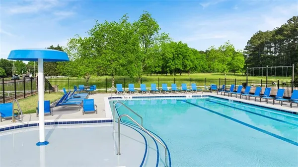 swimming pool view with a seating space and a garden view