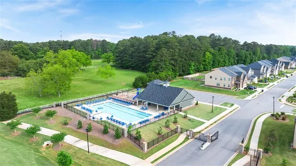 a view of house with swimming pool and furniture