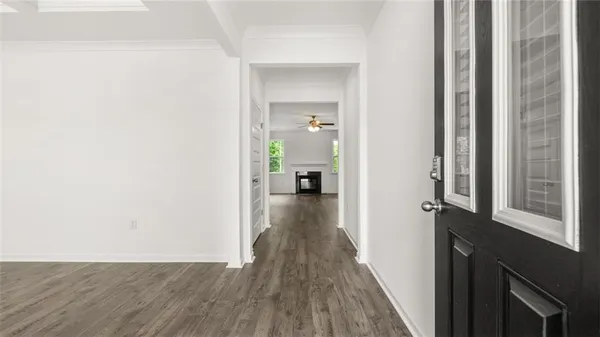 a view of a hallway with wooden floor and staircase