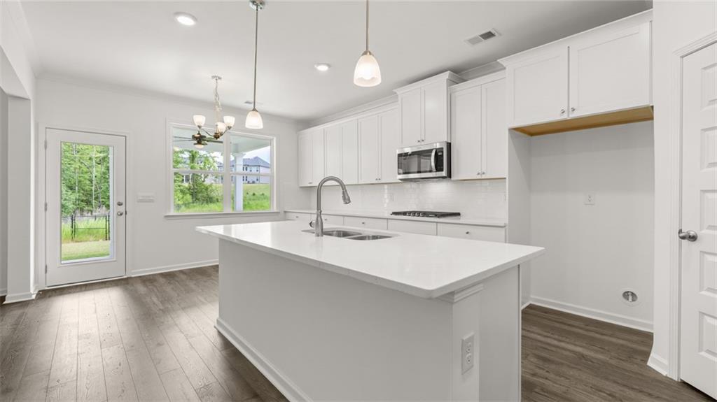1775 Goodwin Drive Hampton, GA 30228 - Photo 9 of 49 a kitchen with a sink a window and wooden floor