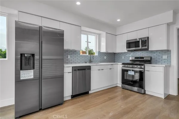 a kitchen with a refrigerator stove and microwave