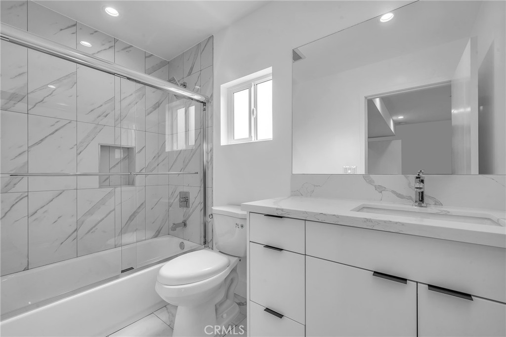 4453 Colfax Avenue, Unit 2 Studio City, CA 91602 - Photo 46 of 60 a bathroom with a granite countertop sink toilet and shower