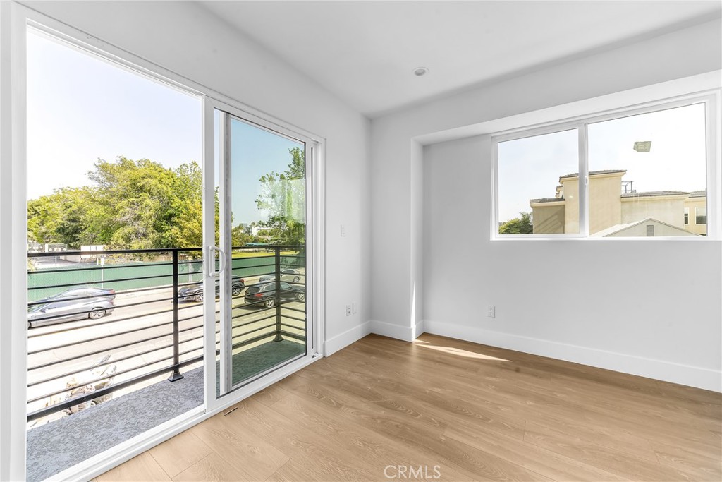 4453 Colfax Avenue, Unit 2 Studio City, CA 91602 - Photo 8 of 60 an empty room with wooden floor and windows