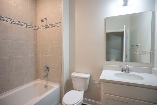 10 Fitzgerald Lane Palm Coast, FL 32137 - Photo 15 of 19 a bathroom with a sink toilet and shower