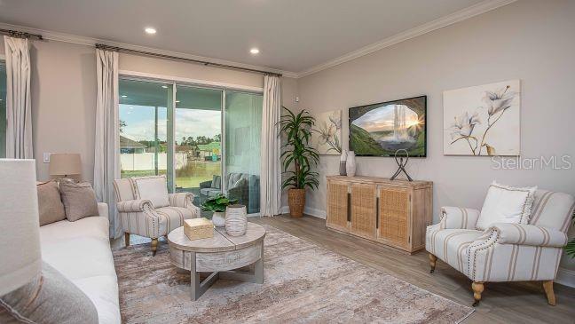 10 Fitzgerald Lane Palm Coast, FL 32137 - Photo 5 of 19 a living room with furniture and a flat screen tv
