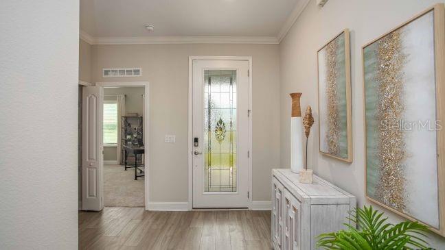 10 Fitzgerald Lane Palm Coast, FL 32137 - Photo 6 of 19 a view of a hallway with wooden floor and a bathroom
