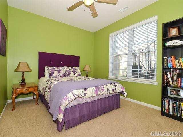 809 Granby Drive, Unit 38 Fort Mill, SC 29708 - Photo 7 of 15 a bedroom with a bed and a book shelf