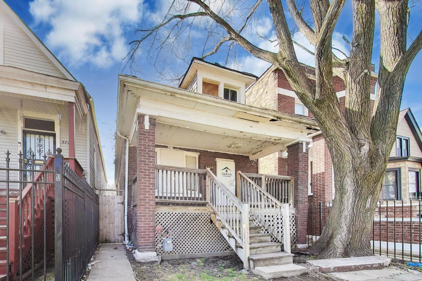 5738 South Ada Street Chicago, IL 60636 - Photo 2 of 22 a view of a brick house with large windows and a tree