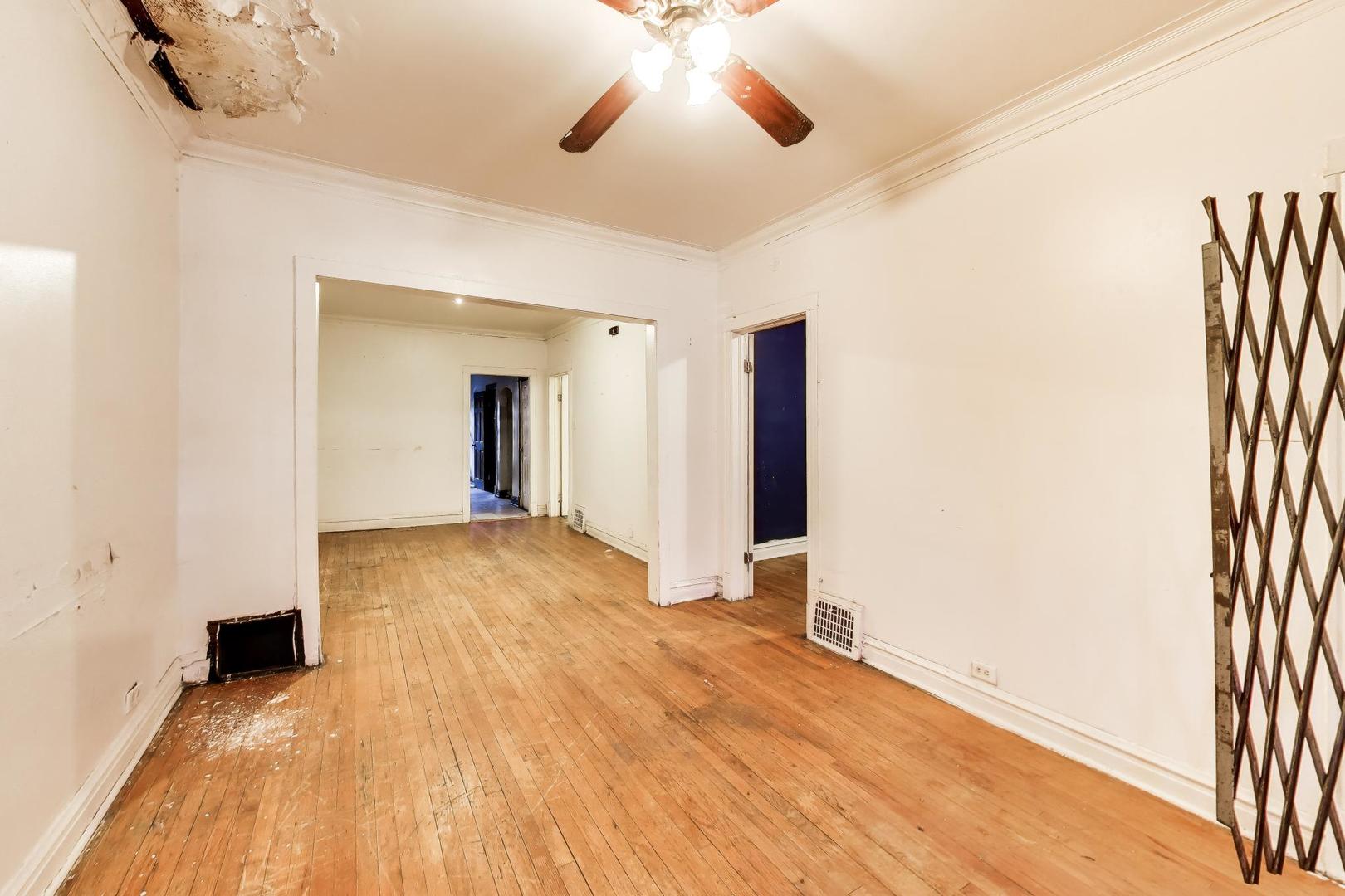 5738 South Ada Street Chicago, IL 60636 - Photo 5 of 22 a view of an empty room with wooden floor and a window