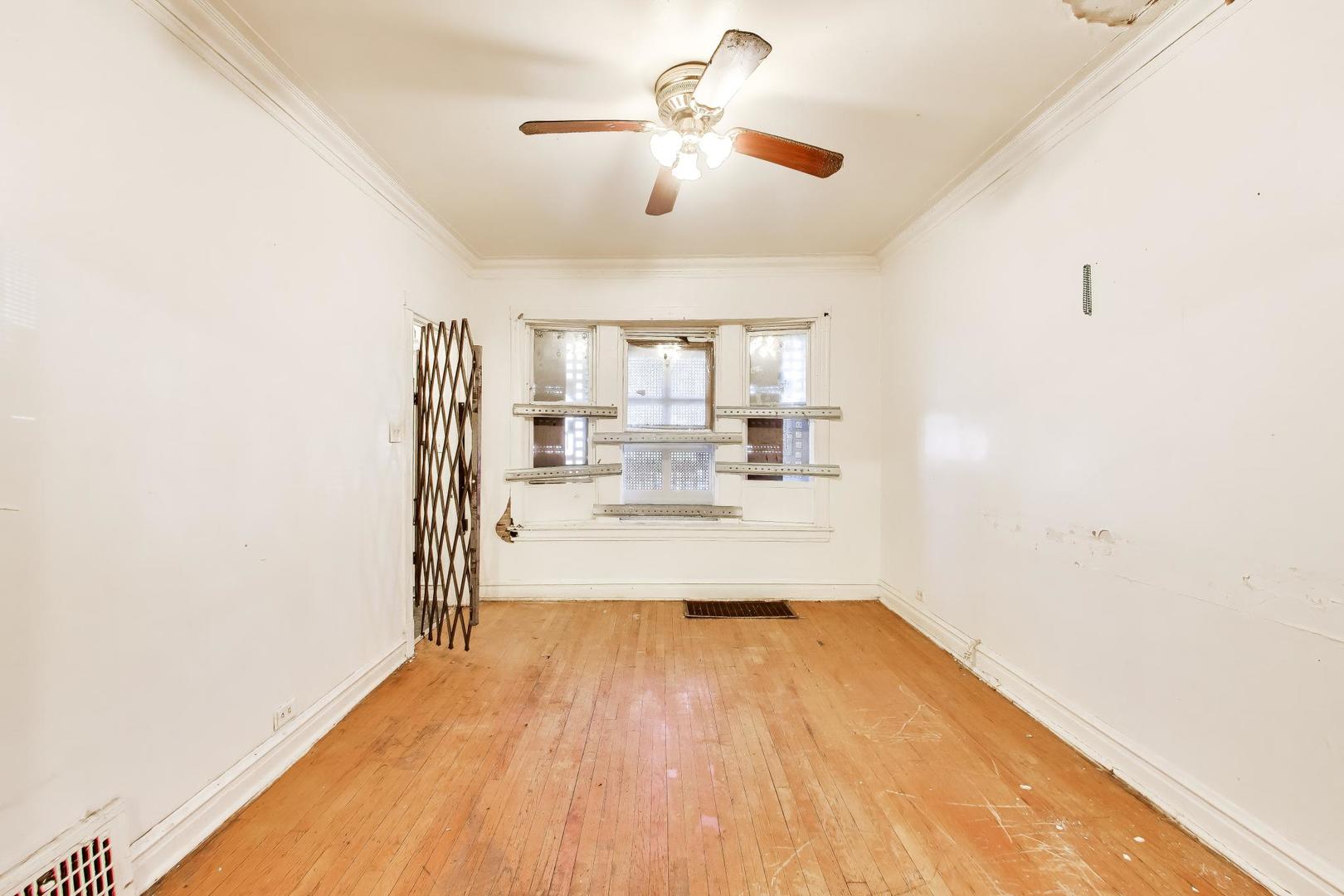5738 South Ada Street Chicago, IL 60636 - Photo 6 of 22 a view of a kitchen with wooden floor a sink and a window