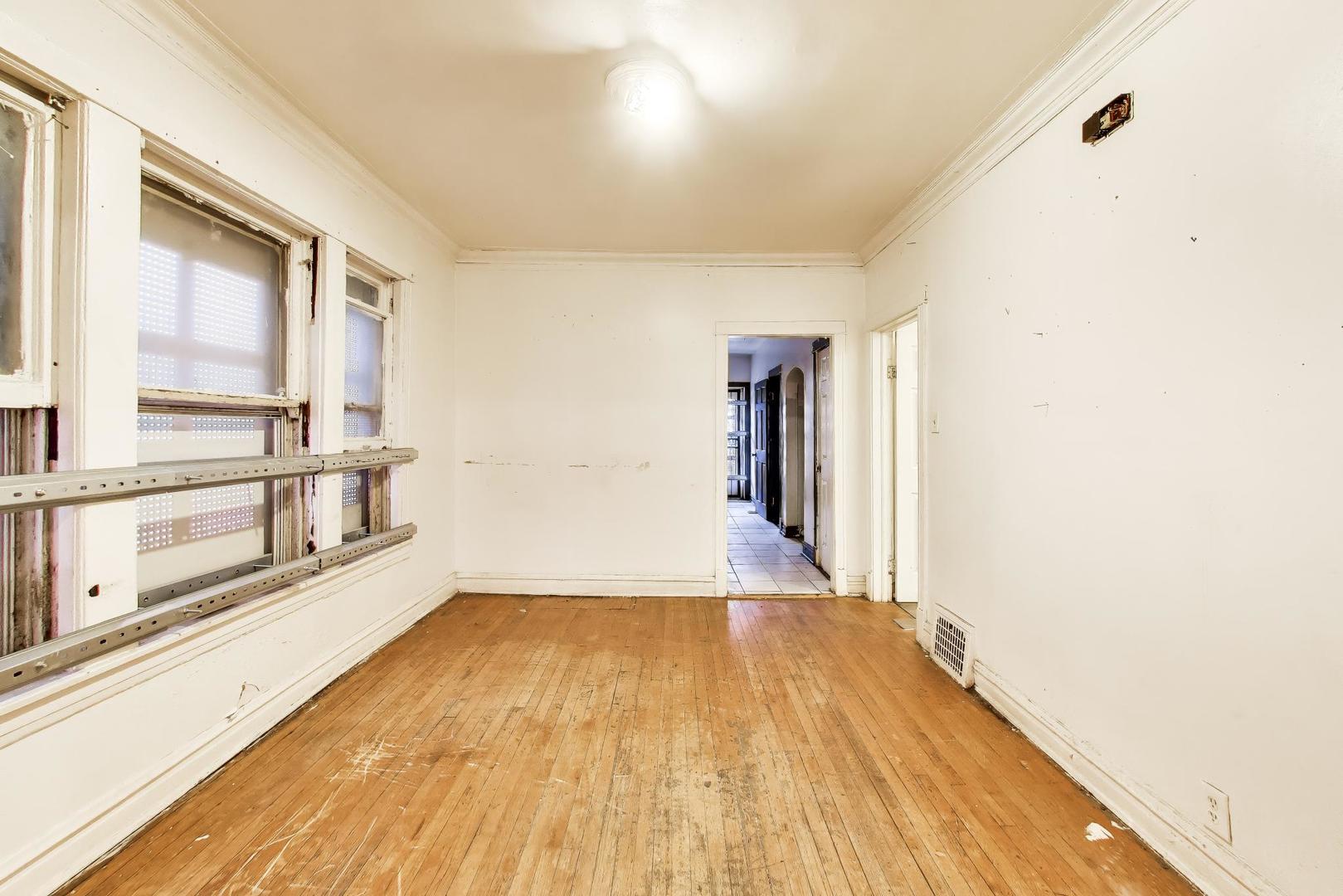 5738 South Ada Street Chicago, IL 60636 - Photo 7 of 22 a view of a room with wooden floor and windows