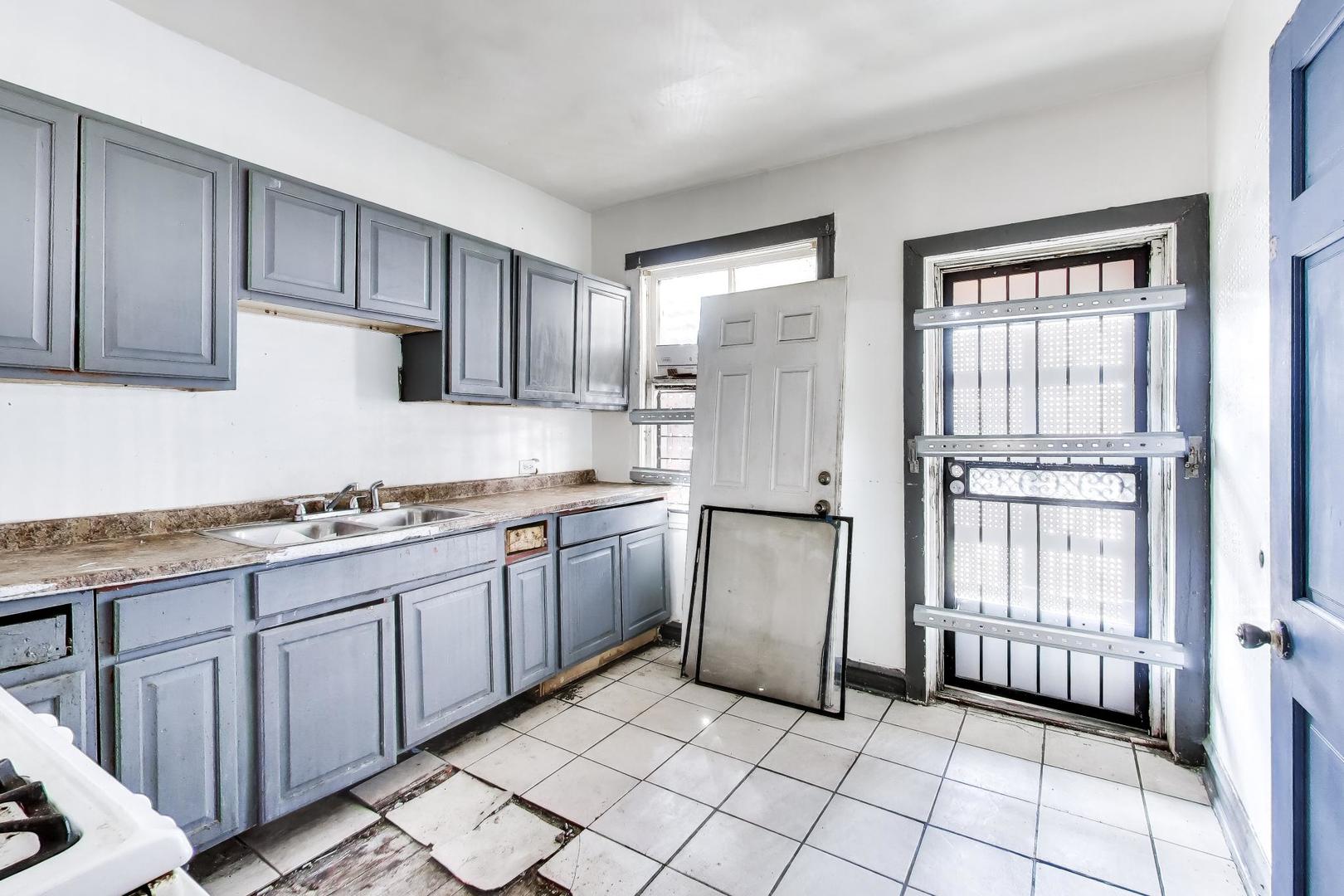 5738 South Ada Street Chicago, IL 60636 - Photo 9 of 22 a kitchen with stainless steel appliances granite countertop a refrigerator and a stove top oven
