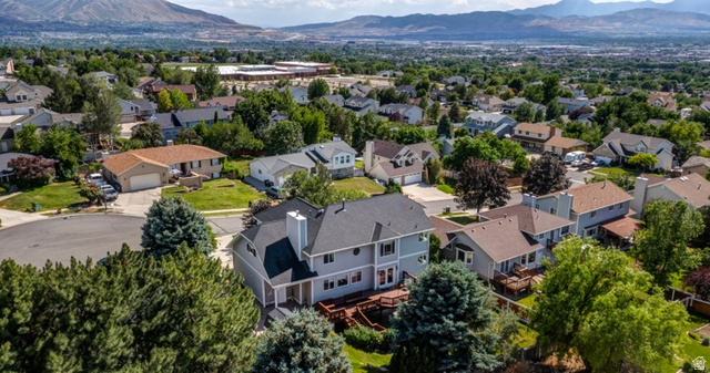 1273 Grayson Court Sandy, UT 84094 - Photo 1 of 27 Aerial perspective highlighting a two-story residence with light gray siding and a dark shingle roof