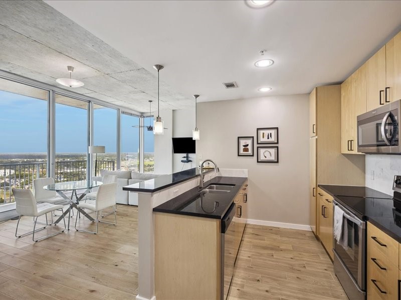 5925 Almeda Road, Unit 12202 Houston, TX 77004 - Photo 1 of 33 The open-concept kitchen overlooks the dining and living areas, making it ideal for hosting guests. Pendant lighting, granite counters, and panoramic views complete this stylish space.