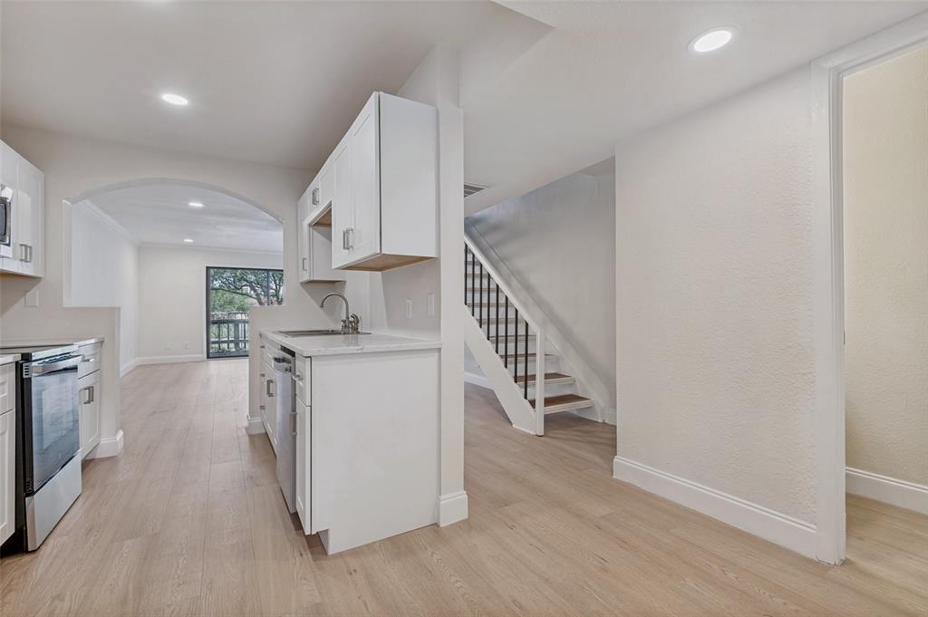 4505 North O'Connor Road, Unit 1121 Irving, TX 75062 - Photo 11 of 34 a view of kitchen with furniture and wooden floor