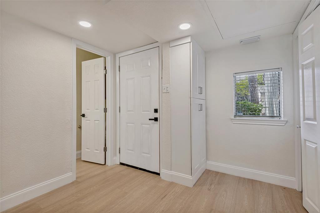 4505 North O'Connor Road, Unit 1121 Irving, TX 75062 - Photo 13 of 34 an empty room with wooden floor and windows